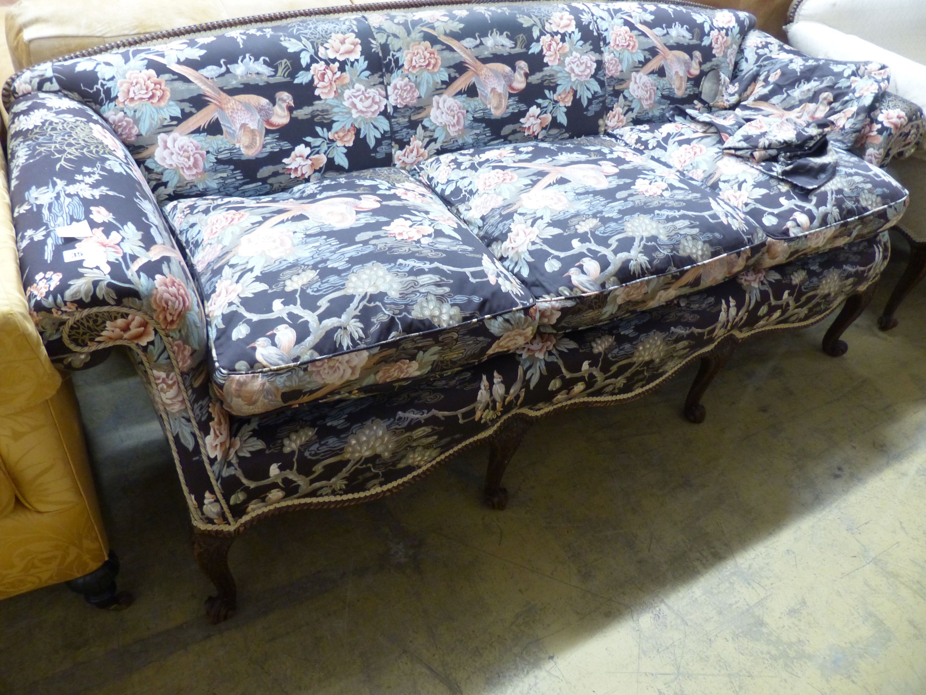 A late 19th century Continental mahogany scroll arm sofa and armchair, sofa upholstered in a floral fabric, on carved cabriole legs W 200 D 86 H 81 cms